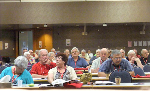 Delegates listen to the Resolutions being debated.