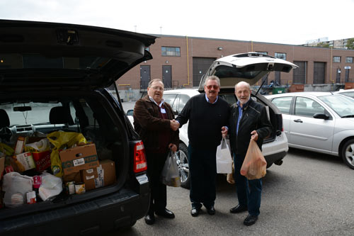 Doug Berry, Chris Wilski and Frank Marek unload food at the Knights Table