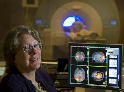 The sound of a functional magnetic resonance imaging machine, shown with study author Cheryl Grady, distracted older adults in the memory test.
