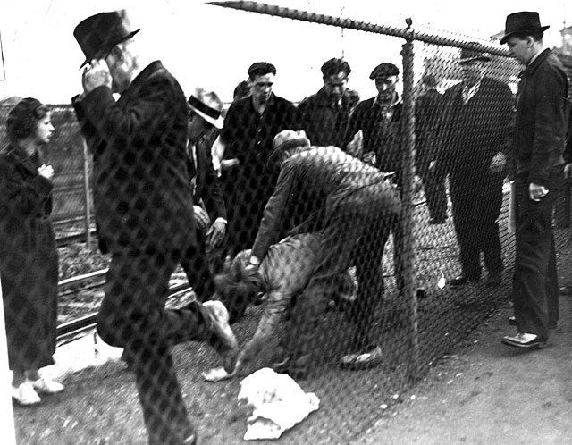 An unidentified UAW organizer is soundly beaten by a group of Ford Service Department employees during the Battle of the Overpass. Second from right is Sam Taylor.