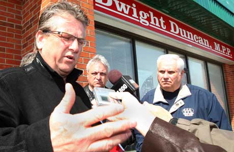 Ken Lewenza, president of the Canadian Auto Workers (L) Mike Vince, CAW local 200 president and Gary Parent Windsor and District Labour Council president speak to the media outside of MPP Dwight Duncan's constituency office in Windsor, Friday, April 10, 2009.Photograph by: Dan Janisse, The Windsor Star