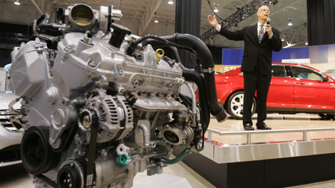 Ken Czubay, Ford vice-president of sales and marketing, discusses the automaker's new EcoBoost engine, left, during a preview at the Cleveland auto show Friday, Feb. 27, 2009, in Cleveland. (AP Photo/Mark Duncan)