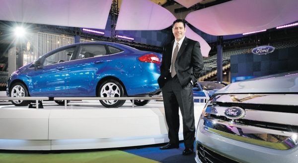 From the floor of the Vancouver International Auto Show on Tuesday, Ford Canada CEO David Mondragon says the Ford Fiesta (in background) gets 50 miles to the gallon or 100 km on five litres of gas. The show runs at BC Place Stadium until Sunday.Photograph by: Ian Lindsay, PNG, Vancouver Sun