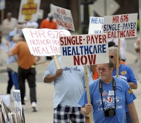 UAW members supporting a single-payer health system protest outside of Cobo Hall, Sunday. (David Guralnick / The Detroit News)