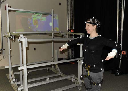 Patty Racco, a Ford manufacturing ergonomic engineer, demonstrates how her movements help digital models become more realistic. (Charles V. Tines / The Detroit News)