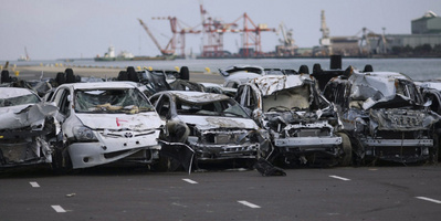 New vehicles damaged by the March 11 tsunami sit lined in a Toyota parking lot at Sendai port, Miyagi Prefecture, northeastern Japan, Monday, March 28, 2011.