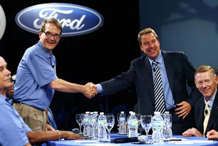 UAW president Bob King, left, shakes hands Friday with Bill Ford Jr., executive chairman of Ford Motor Co., during the traditional handshake to launch the start of contract negotiations at the River Rouge Plant in Dearborn. CEO Alan Mulally, right, looks on. (Gary Malerba / Special to The Detroit News)