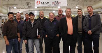 CAW President Ken Lewenza joins with Lear Corporation Unit Chairperson Scott Bateman (fourth from right) at 25th anniversary celebrations at the Local 222 plant in Whitby, Ontario recently. 