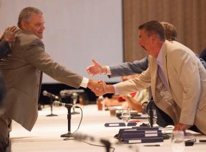 David Wenner, left, general director of labour relations for General Motors, shakes hands with Chris Buckley, chairperson of the CAW’s GM master bargaining committee, in Toronto on Aug. 14, 2012