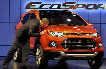 Ford CEO Alan Mulally kisses the new EcoSport, among the vehicles Ford is expected to launch this year in China. (Associated Press