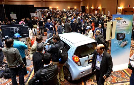 Visitors flood the 2013 International CES electronics show, where automakers stressed efforts to ramp up more advanced Internet-based radio and other music streaming. (Joe Klamar / Getty Images)