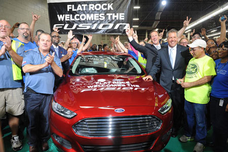 From left, foreground, Tony Bondy, United Auto Workers Local 3000 chairman; Jimmy Settles, UAW vice president; Tim Young, plant manager, and Joe Hinrichs, president of Ford of the Americas, and a group of UAW line workers launch production of the 2014 Ford Fusion at Ford's Flat Rock plant Thursday, Aug. 29, 2013. (Charles V. Tines / The Detroit News)