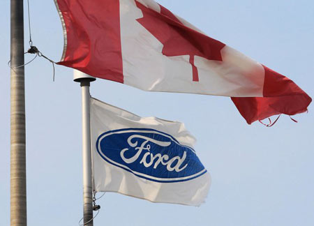 The Ford corporation flag and the Canada flag fly, at the Ford Essex Engine Plant in Windsor, Ont. (Dan Janisse/The Windsor Star)