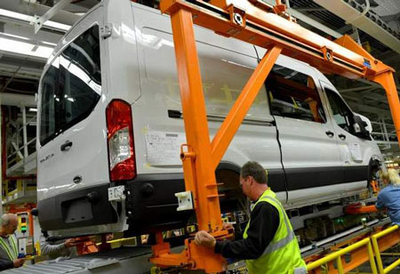 Mike Shearer works on a Transit at Ford's Kansas City Assembly Plant. It has multiple configurations, including three body lengths, two wheelbases, three roof heights and van, wagon, chassis cab and cutaway variations. (Sam VarnHagen / Ford Motor Co.)