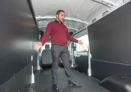 Joe Celentino, sales representative at Village Ford in Dearborn, shows how the roominess inside a Transit van. Ford Motor Co. says sales of the new Transit, which replaced the E-Series, have been brisk, with nearly 5,000 sold in November alone.(Photo: John M. Galloway / Detroit News)