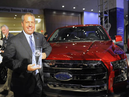 Ford Executive Vice President Joe Hinrichs shows off the award for Truck / Utility of the Year during day one of press previews at the North American International Auto Show in Detroit on January 12, 2015. (Photo: David Coates