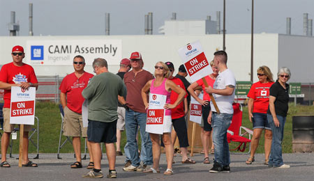 Employees of the GM CAMI assembly factory stand on the picket line in Ingersoll, Ont., on Sept. 18, 2017. THE CANADIAN PRESS/Dave Chidley