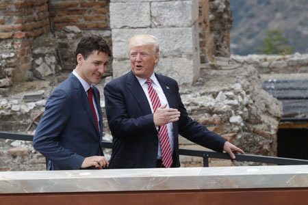 Canadian Prime Minister Justin Trudeau, left, and U.S. President Donald Trump talk as they attend the Summit of the Heads of State and of Government of the G7 on May 26. A lot is happening this month in Canada-U.S. trade with at least four actions on the punitive front that Canada will be watching in June.  (PHILIPPE WOJAZER / AFP / GETTY IMAGES) 