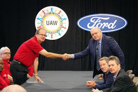 UAW President Gary Jones and Ford CEO Jim Hackett shake hands to formally kick of 2019 contract negotiations.