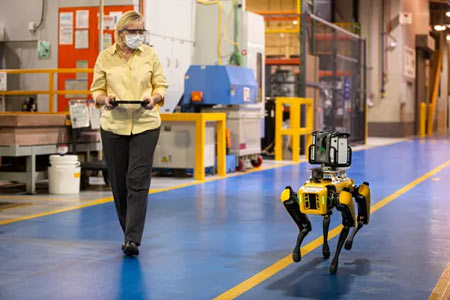 Paula Wiebelhaus navigates Fluffy the robot dog through the Van Dyke Transmission Plant. Ford is leasing two of the robots to map out its factories. (Photo: Ford)