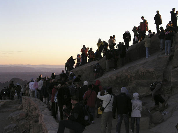 Pilgrims and hikers at the summit of Mount Sinai watch at dawn as the sun moves across the mountains and hills. Visiting far-off places, whether holy or not, can have a spiritual effect on any of us simply by impacting our view of the world. 