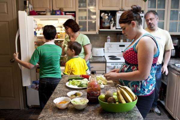 Kim and Warren Horricks of Calgary prepare dinner with Nate, 7, Aaron, 12 and Amanda, 14, who recently found out that along with running a risk of diabetes, she has high blood pressure. Her mother has tried to cut the fat and sugar in the family diet, but hasn’t made a dent in their sodium intake. 