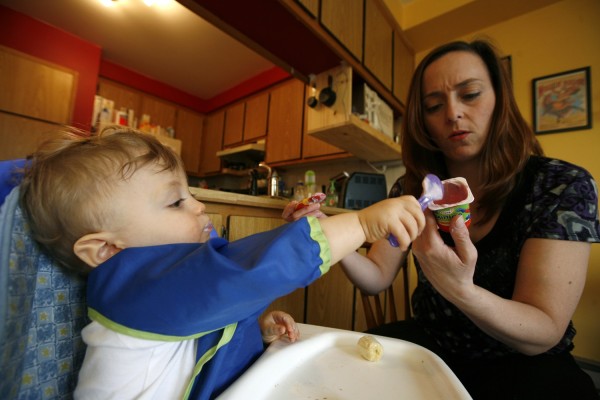 Jennifer McIntosh in Montreal reads the label on the yogurt she’s giving her 18-month-old son Tyler. With a family history of hypertension, she’s already being careful to limit his sodium intake. That night’s dinner: puréed roast beef, potatoes and corn, yogurt with bananas and a homemade pumpkin muffin.